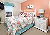 Comfy queen sized bed with coastal furnishings and paint!