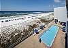 Direct views of the on-site pool and beach access from balcony