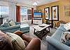 Enjoy this colorful & spacious living room with plenty of seats for everyone!