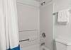 Features a shower/tub combo.