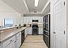 The kitchen is well stocked and includes stainless steel appliances.  Notice there is plenty of counter space for preparing your favorite meals. 