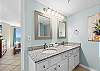 Double Sinks and long mirror are perfect for this delightfully furnished Master Bath.