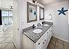 Double Sinks and long mirror are perfect for this delightfully furnished Master Bath.