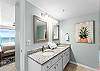 Double Sinks and long mirror are perfect for this delightfully furnished Master Bath.