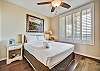 Beautiful plantation shutters are a nice touch to this bedroom.   