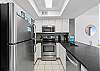 Stainless steel appliances & great lighting makes this kitchen easy to work in. 