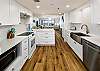 Gorgeous open kitchen! with beautiful white cabinets and counter tops! 