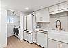 Coffee bar and laundry area located conveniently next to the kitchen.