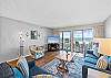 The living area is large and inviting. Plenty of seating and the cozy sofa features a queen-size sleeper.