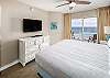 King size bed in this beachfront master bedroom with private entrance to the balcony