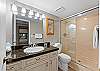 Walk-in shower with sliding glass door for extra convenience