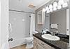 The guest bathroom features a shower/tub combo.