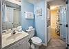 The bathroom has facilities beside the bedroom and the bunk area, with the shower and the washer and  dryer in between them.