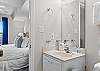 The bathroom has facilities beside the bedroom and the bunk area, with the shower and the washer and  dryer in between them.