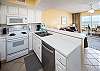The kitchen has full-size appliances and is stocked with dishes and cooking supplies for all your vacation meal needs.