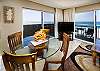 Dual sliding glass doors offer plenty of access to the wrap around balcony. Living room features a large flat-screen TV