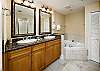 Granite counter tops with deep dish sinks and jacuzzi style tub