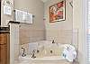 Master bath featuring a jetted tub perfect to relax in after a long day soaking up the sun. 
