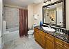 Spacious shower, tiled floors, and private entrance to the second guest bedroom