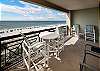 Bistro table and chairs, two lounge chairs, and a perfect view of the emerald waters