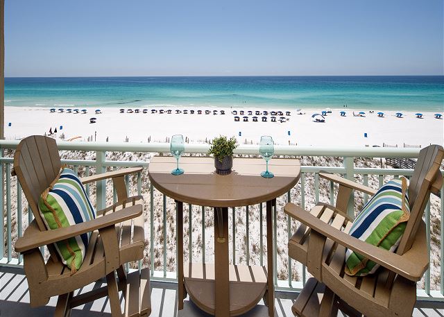 BAR HEIGHT CHAIRS AND TABLE LET YOU LOOK OVER THE RAILING AT THE STUNNING GULF AND BEACH SERVICE. FOUR EXTRA CHAIRS IN CORNER.