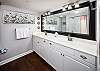 Master bath boasts double sinks and a tub/shower combo.