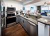 Brushed nickel hardware and newer cabinet paint make the kitchen in 510 unbeatable.