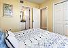 2nd bedroom features its own private bathroom, wall mounted flat screen TV, and a Queen bed.