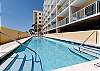 BEACHSIDE pool with enough space for everyone to lounge around on the deck or take a dip in the deep end