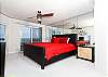 Large beach front master bedroom with a king size bed and access to the units private balcony