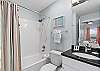 his bathroom features a shower and tub combination! 