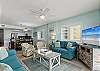 Living Room: Bright, beachy vibes with fun seating and a view for perfect gatherings!