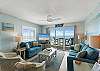 Living Room: Bright beach vibes with stunning views, comfy seating, and vibrant decor await you!