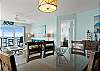 The dining table seats 6 guests and more seating is available at the breakfast bar