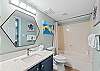 Second bathroom featuring a tub / shower combo as well & lots of counter space.