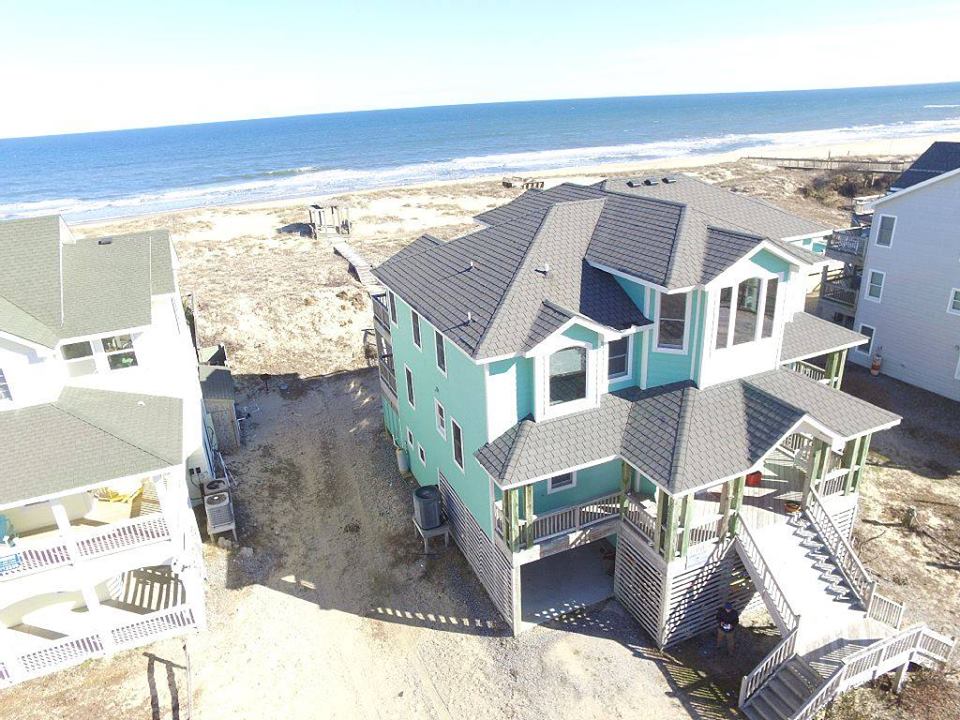 This aerial photo was taken before the tiki bar and front porch extension, but does show how close the ATLANTIC ocean is.. steps away at Sands of Time vacation rental, Carova Beach 4x4 Northern Outer Banks NC