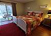 Lower level bedroom offers a king bed with doors leading out to the spa and river.