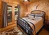One of two main level bedrooms. This cozy bedroom offers access to the screened in porch and features a queen bed.