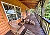 The covered porch on the main level offers plenty of space to drink your morning cup of coffee or evening glass of wine as you enjoy the Blue Ridge Mountains. 