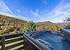 Relax in the hot tub as you enjoy the mountain views.