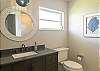 Second bathroom with single vanity and large shower