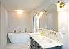 Master bath with large soak-in tub and dual vanity