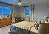 Queen bed with coastal furnishings. 