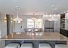 Bar into dining area with sunny kitchen window view