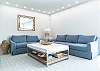 Coastal themed living room provides comfort and functionality for everyone at the Island Blue location