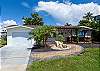Front view of the house which includes a swing for sipping coffee in the morning and watching the sun come up to great you at your Island destination. 