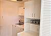 laundry room with washer, dryer, extra storage and wine fridge