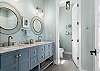 Primary Ensuite features dual vanities and large shower.