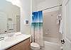 Queen bedroom's full private bathroom with shower/tub combo.