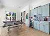 ground floor family/game room with kitchenette located off of the pool area